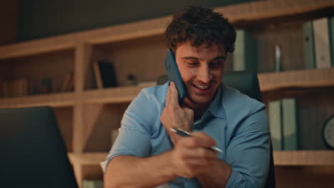 happy employee speaking cellphone at evening agency close up. smiling manager