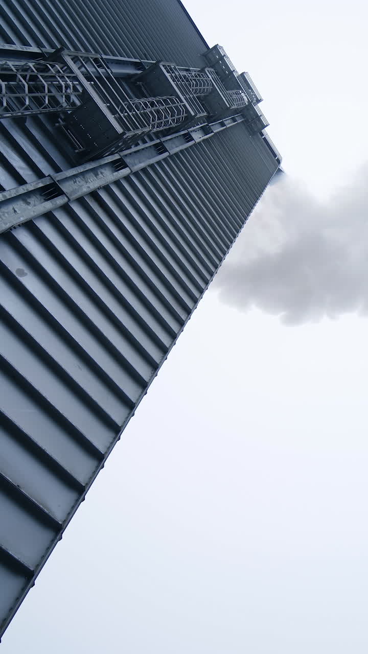 Modern metal factory warehouse. White vapor from manufacturing pollute