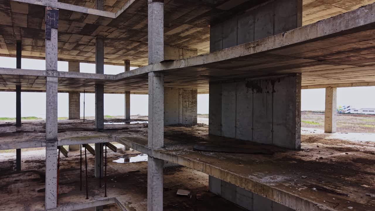 Abandoned building structure reveals urban decay near the coastline