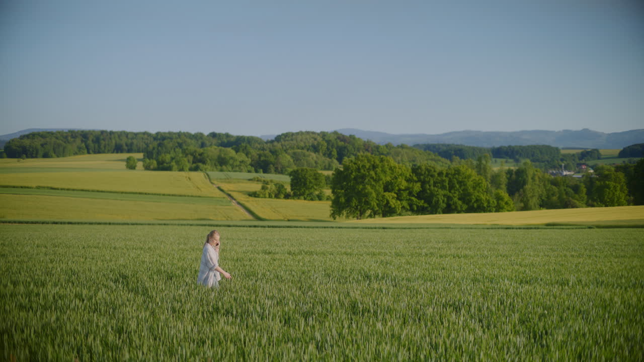 Woman Walking in Agricultural Field Talking on Phone in Rural Landscape