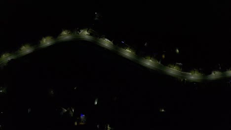 neighborhood with house lights and fireworks on street