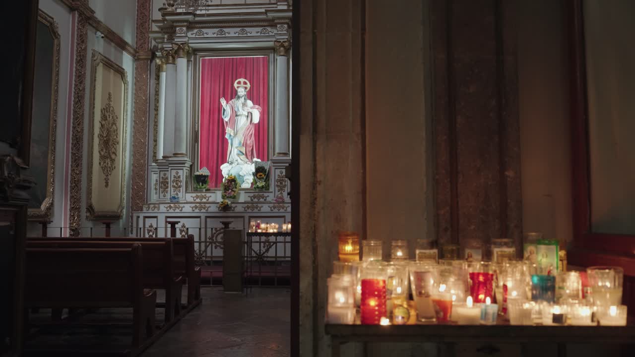Interior of a church with statue and candles