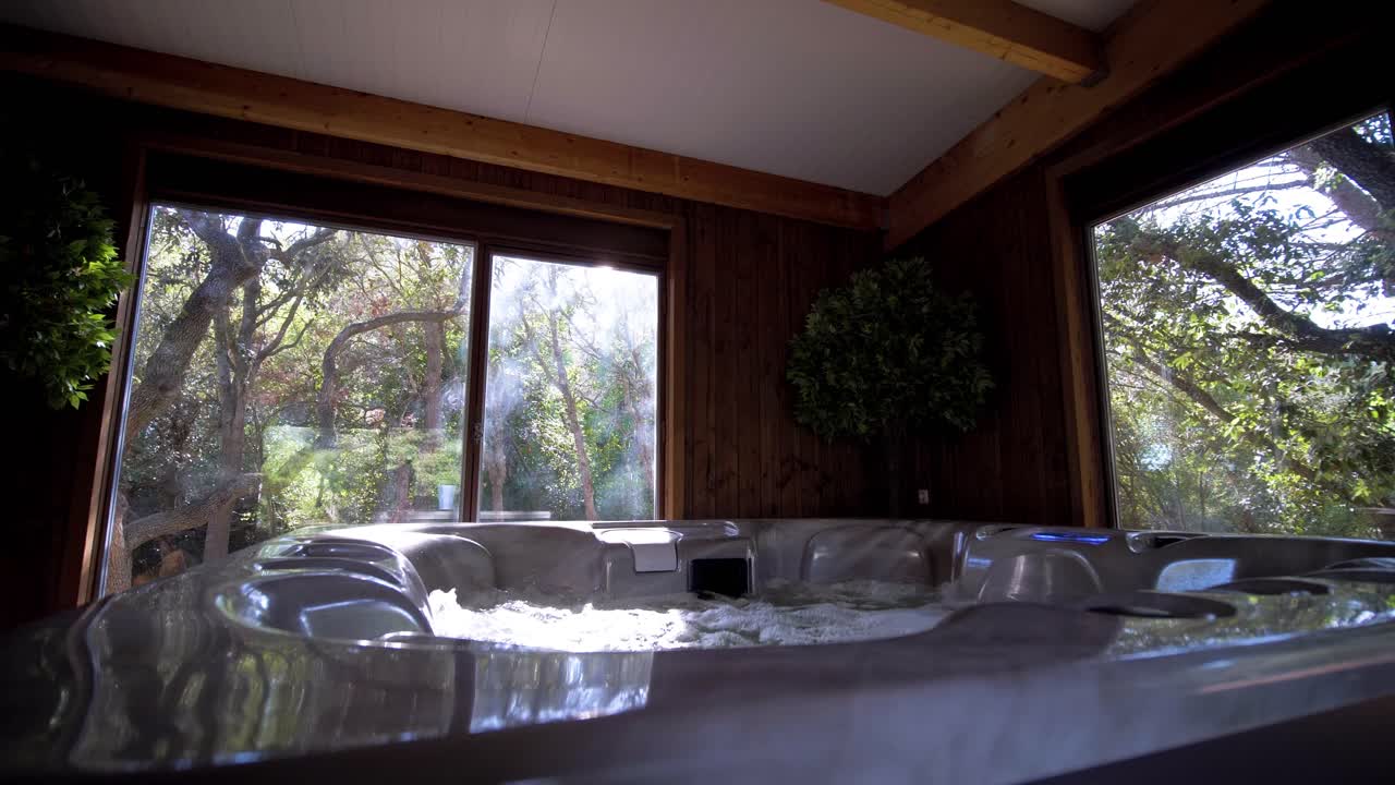 Slow motion shot of sunlight lighting over a hot tub within a villa in France