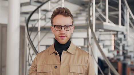 Portrait-of-a-young-curly-man-in-glasses-who-is-smiling