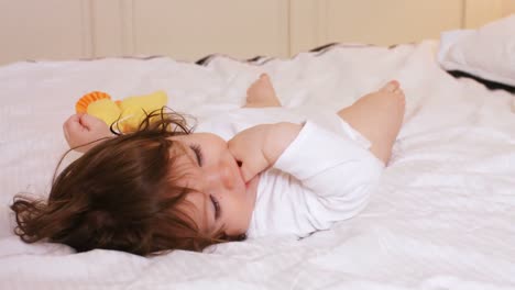 Cute-baby-girl-playing-on-bed