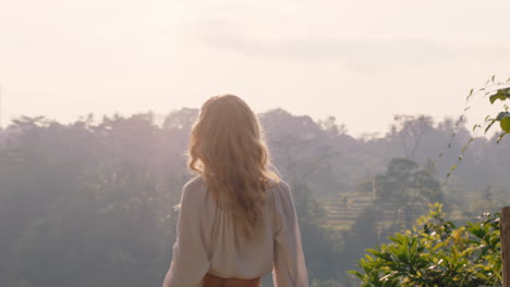 happy-woman-looking-at-tropical-jungle-at-sunrise-feeling-joy-on-summer-holiday-adventure-enjoying-new-day-in-paradise