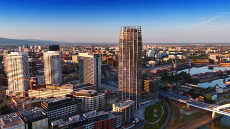 bratislava sunset skyline. bratislava modern skyline glows in a sunset, reflecting off the danube river and showcasing urban life