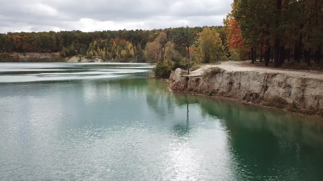 Trees and lake from above. Aerial view of wild area with blue lake and forest