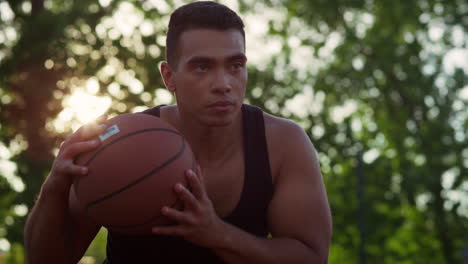 closeup focused streetball player making attempt to score goal outdoors.