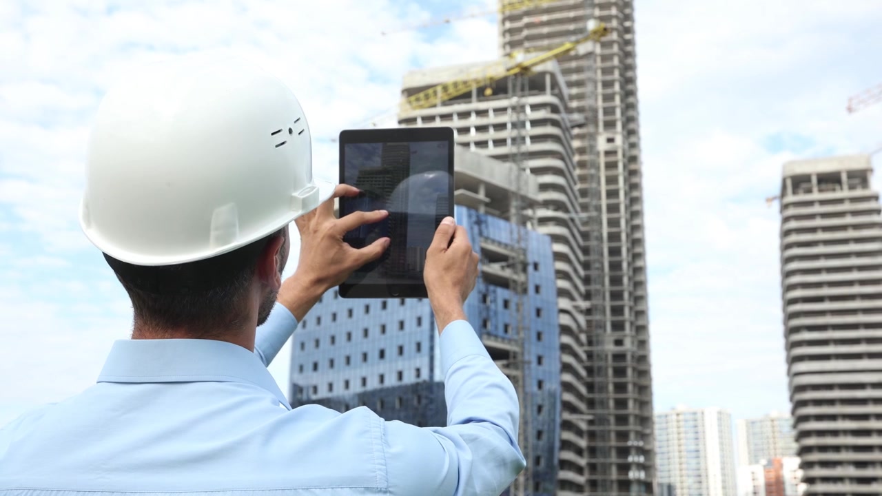 Engineer in Hard Hat Using Digital Tablet at Construction Site