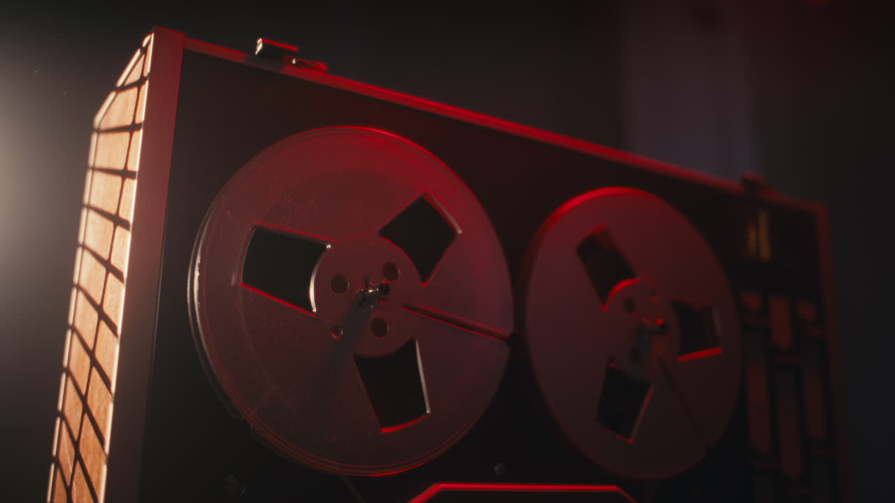 A vintage tape recorder in a red blinking light
