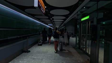 people walking through a modern train station