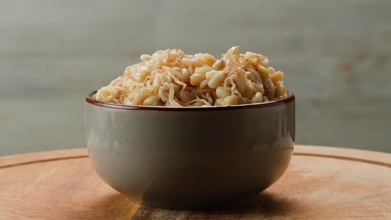 Salted soybean fermented in jar, chinese soy production, marinated food, germinated soy close up in cafe restaurant.