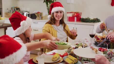 Caucasian-girl-passing-food-plate-to-her-mother