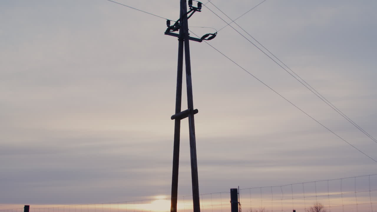 Wide shot of an electricity pylon at sunrise