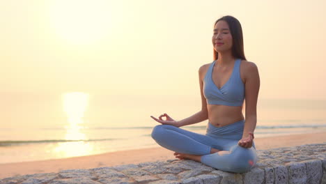 meditation - asian yoga woman meditating at beach sunset