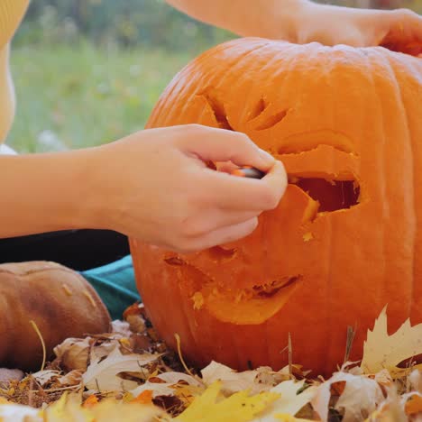 young woman carves a pumpkin 2