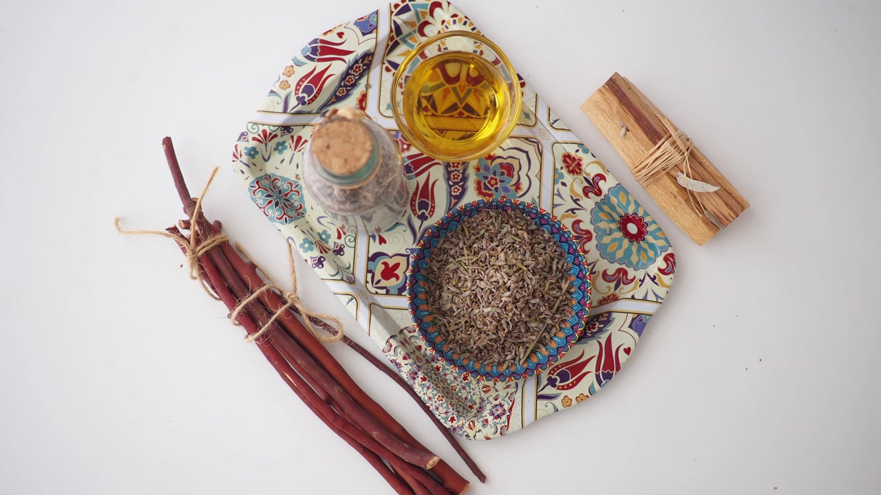 Flat Lay of Natural Herbs, Essential Oil, and Spiritual Items