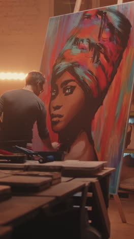 artist painting a colorful portrait of an african woman