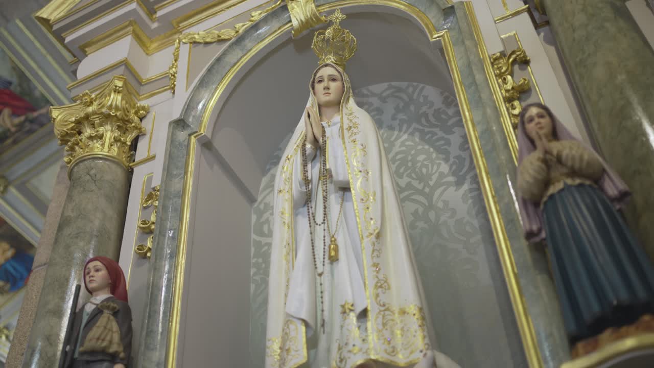 Our Lady of Fátima statue with the shepherd children on ornate church altar