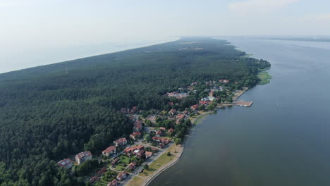 Small-town-of-Juodkrante-on-coastline-of-Curonian-lagoon,-aerial-drone-view