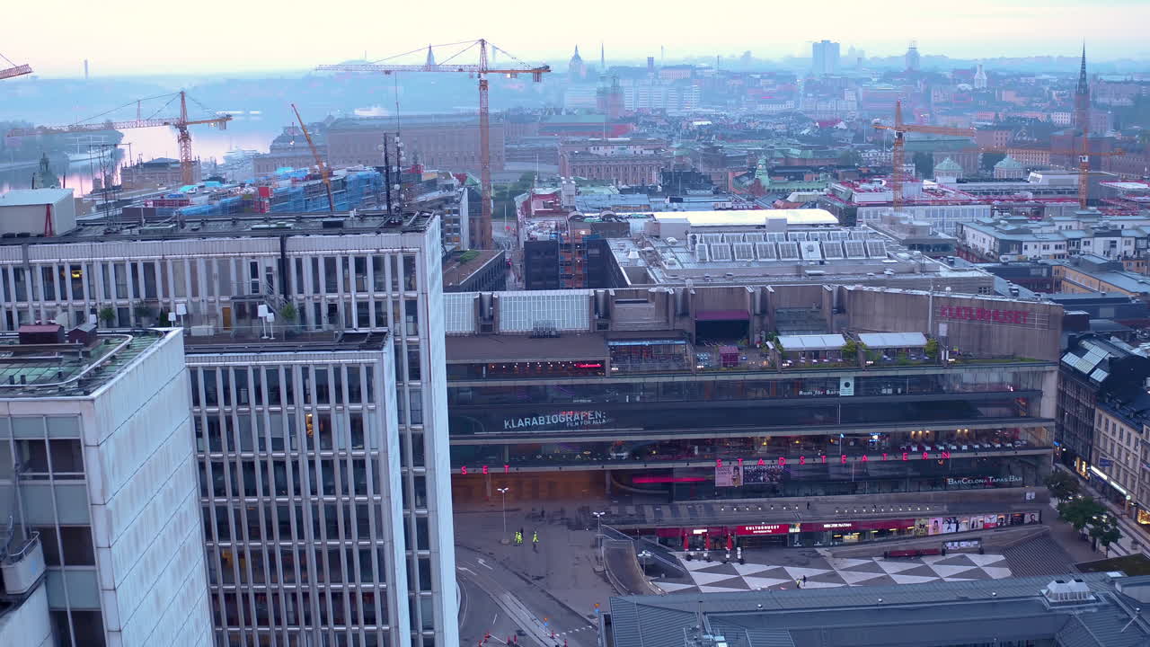Aerial View of Stockholm Cityscape with Construction Cranes at Dusk