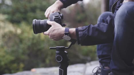 cameraman stabilizing camera on gimbal, close up shot