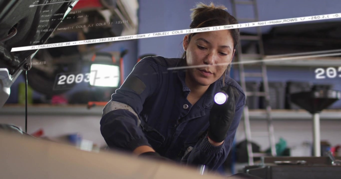 Auto mechanic holding lamp leaning on engine probing battery as year overlay sliding beam crossing