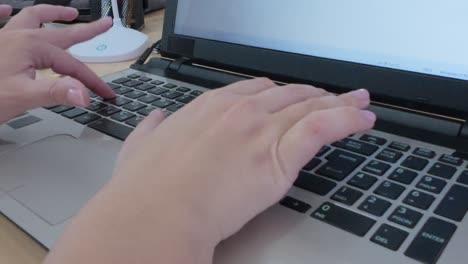 close-up dynamic shot of hands actively typing on a laptop keyboard