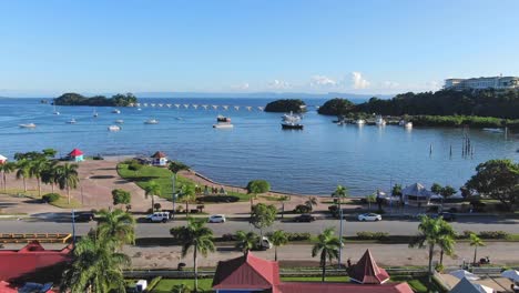 Santa-Barbara-de-Samana-seafront-with-pedestrian-bridge-in-background,-Dominican-Republic