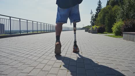 person with prosthetic leg walking in park