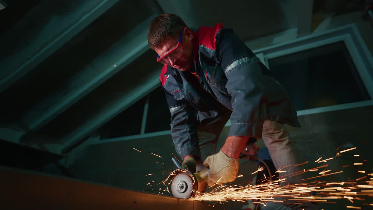 Man Cutting Metal with Angle Grinder Producing Sparks