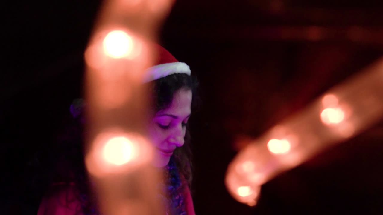 Woman in Santa Hat with Christmas Lights