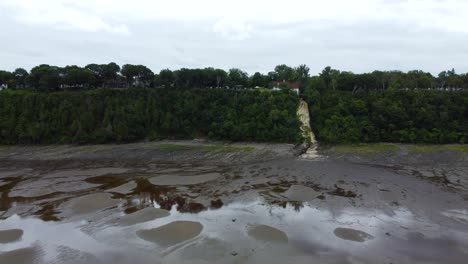 Waterfall-Flowing-into-the-Saint-Lawrence-River-in-Quebec,-Canada---Aerial