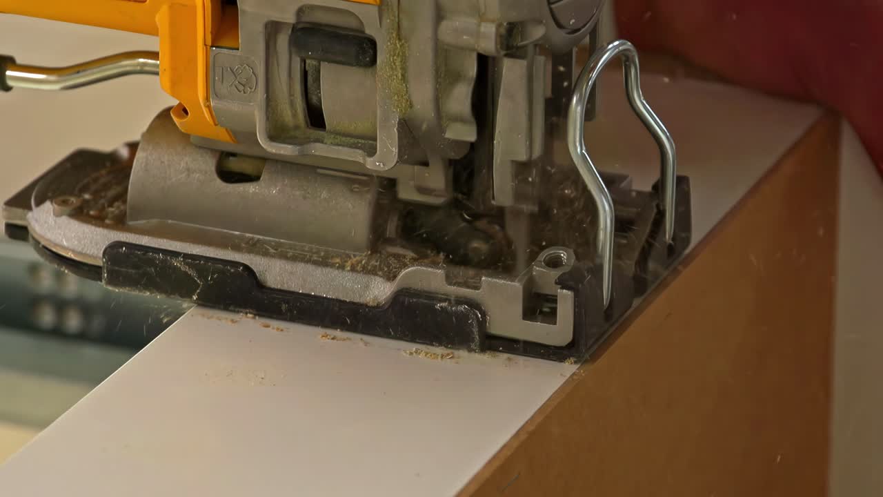 Jigsaw in action, cutting through material with precision during a woodworking or construction task