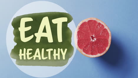 animation of eat healthy text over halved grapefruit on blue background