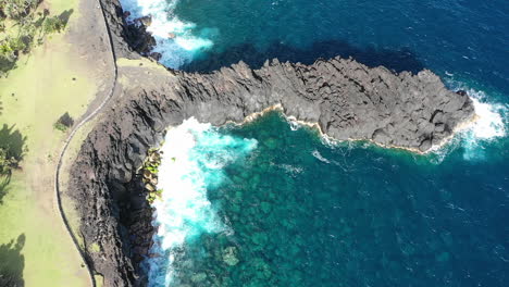 Aerial-view-over-the-Lava-rock-formation-of-Cap-Mechant-and-the-coastline-of-Reunion-Island