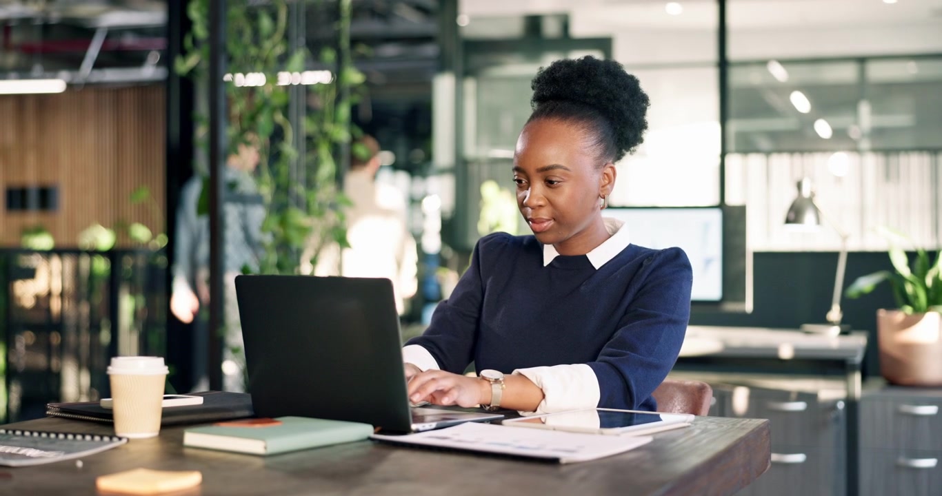 Professional Woman Working on Laptop in Modern Office