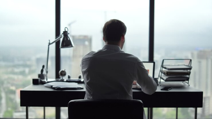 Manager looking at graphs on laptop