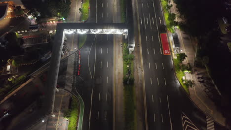 Aerial-tilt-down-into-overhead-shot-of-empty-multi-lane-motorway-during-coronavirus-epidemic-in-urban-city-center