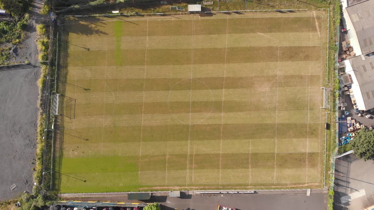 Empty Football Field Near A Warehouse In Dublin, Ireland - aerial