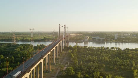 Orbital-of-Zarate-Brazo-Largo-road-and-railway-complex-cable-stayed-bridge-crossing-Parana-river-connecting-Buenos-Aires-and-Entre-Rios-at-golden-hour,-Argentina