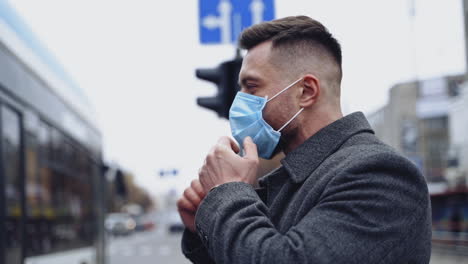 man wearing face masks during coronavirus outbreak. young man walking down the street wearing mask to protect himself from the coronavirus during the pandemic