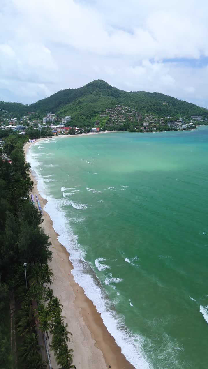 Vertical aerial flyover captures sweeping Kamala Beach and surf, Phuket