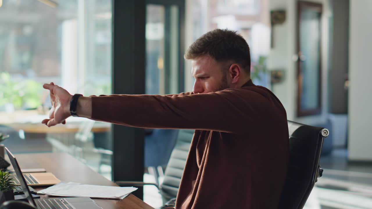 Tired manager stretching hands making break from laptop work in office closeup