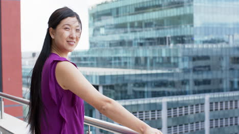 portrait of smiling asian businesswoman in office, slow motion, copy space