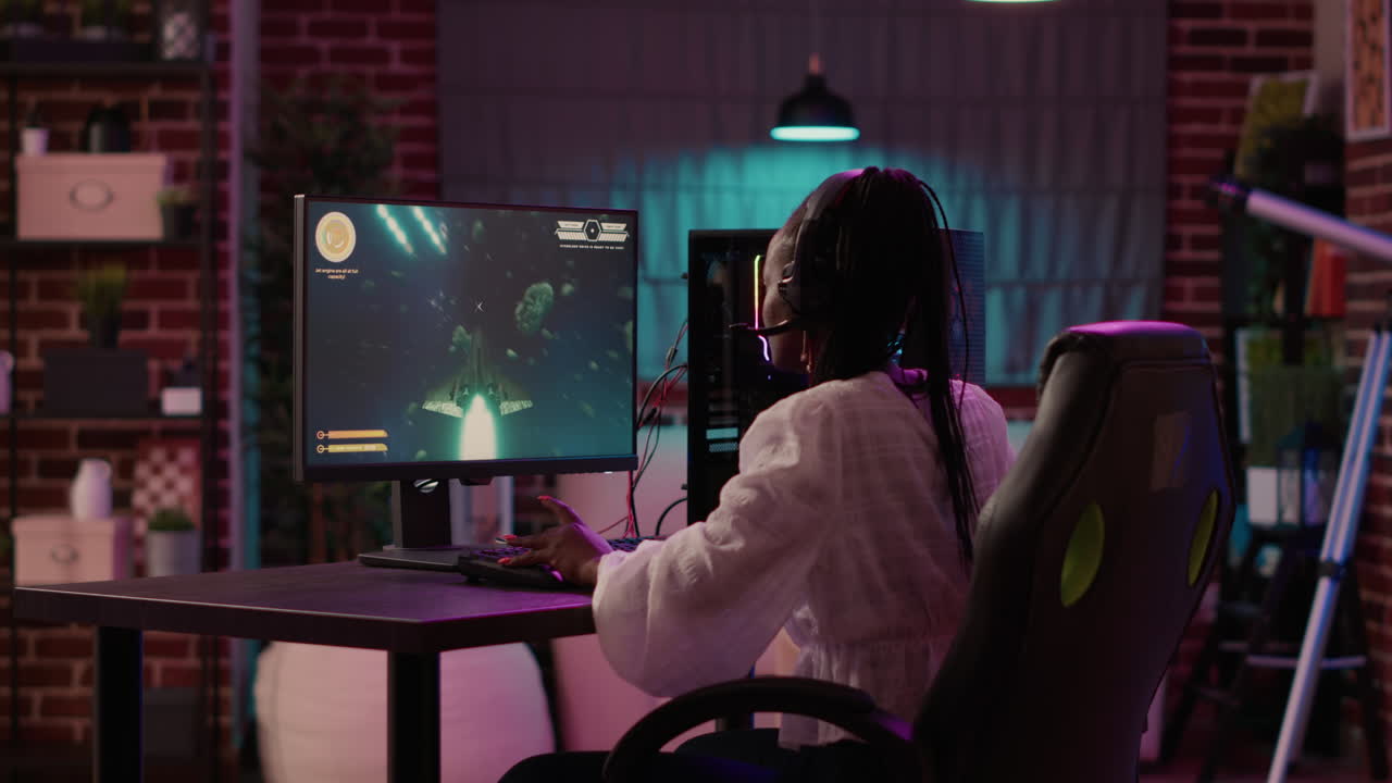 Woman playing multiplayer space shooter simulation enjoyingh free time using pc gaming setup