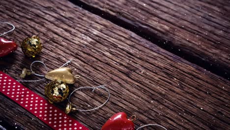 Falling-snow-with-Christmas-decoration-on-wood