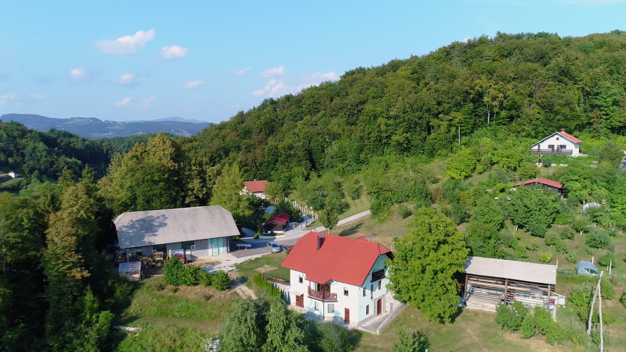 fly over Alpine chalets and forest at Krvavec, a renomed Slovenian ski resort