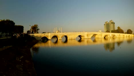 ancient roman bridge across the river in the center of the turkish city of adana